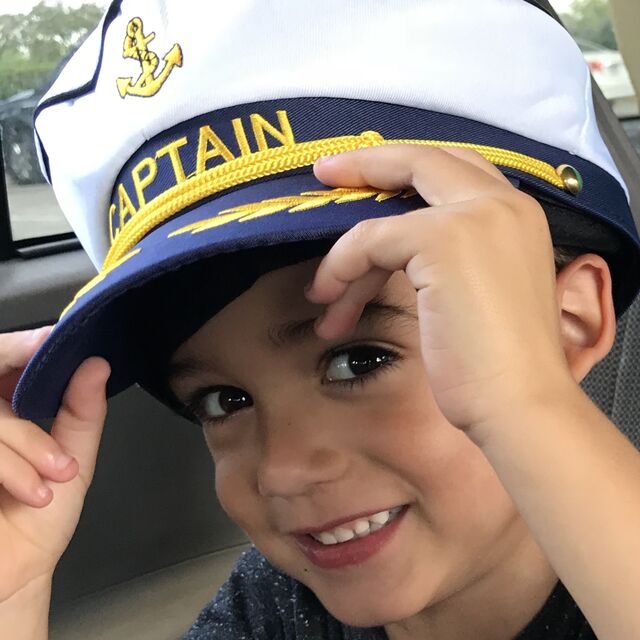 A young guest in a captain's hat